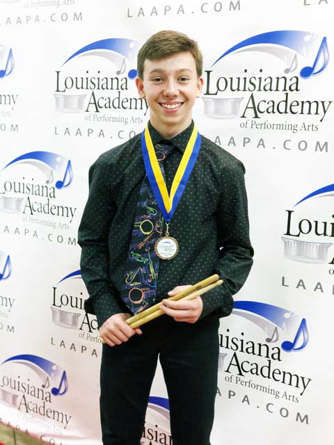 Student in Elmwood receiving his award for learning to play music