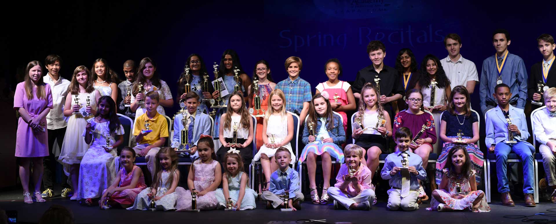 Photo of young musicians after their recital on stage.