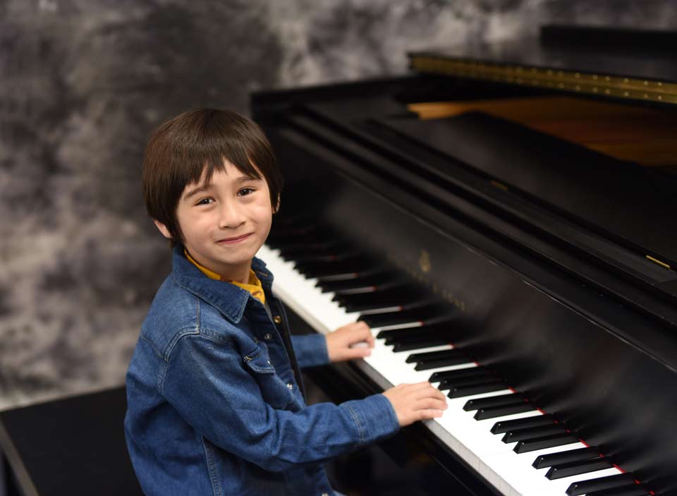 Kid playing the piano in Kenner, LA