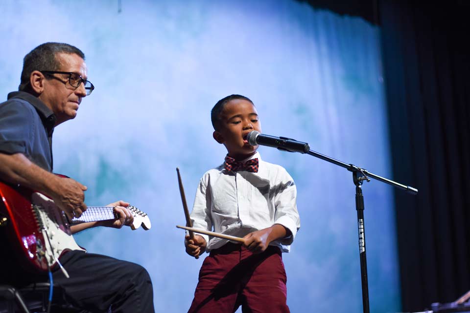 Kids in Kenner learning to play music.