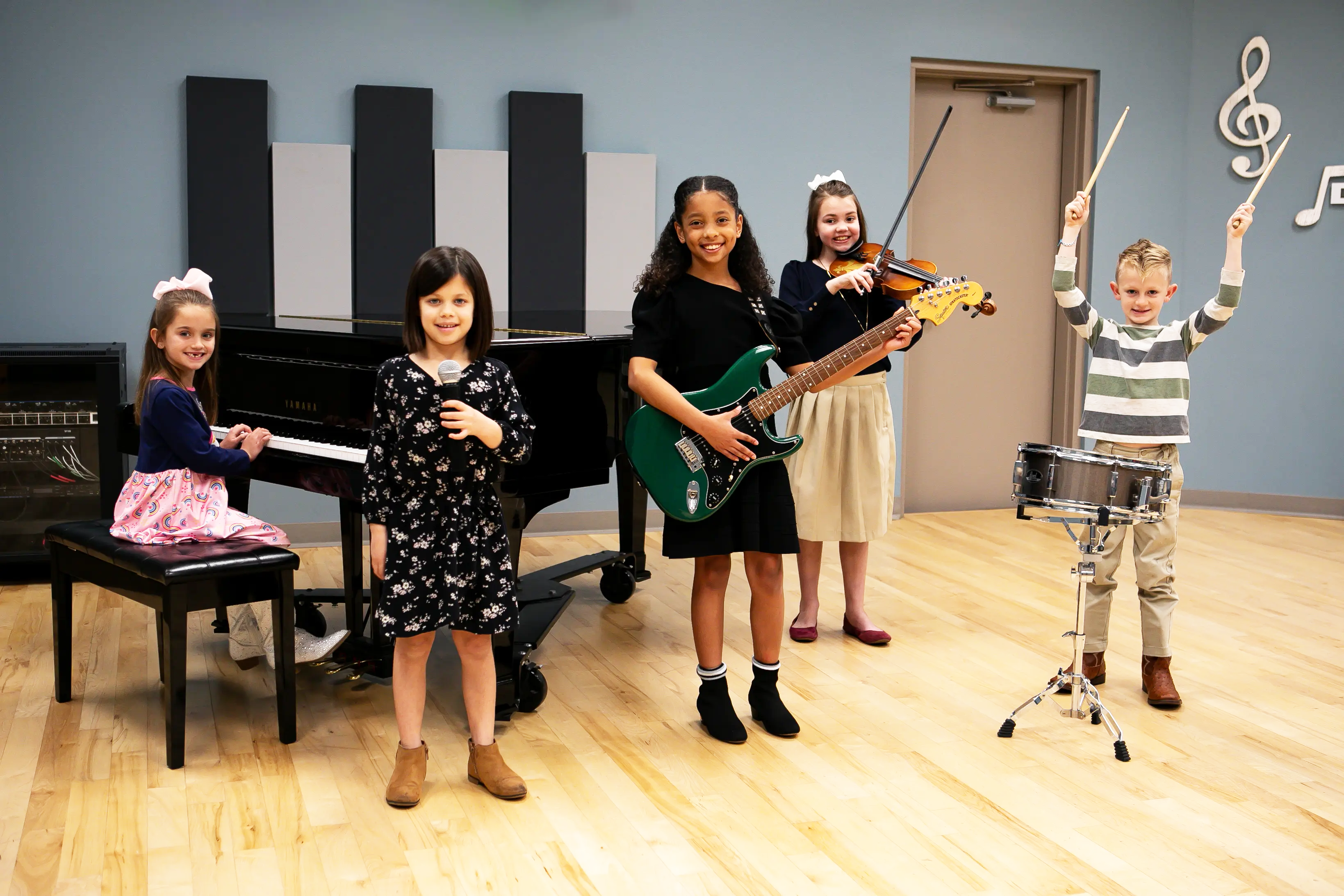 Kids taking music lessons on piano, voice, guitar, drums and violin at LAAPA in Mandeville, LA